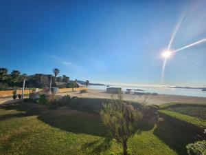 a view of the beach and the ocean on a sunny day at Le Topaze in Grimaud