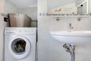 a bathroom with a washing machine and a sink at Villa Ciò in Bonassola