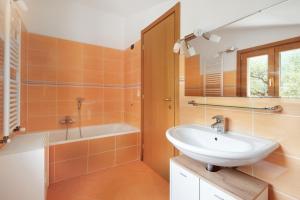 a bathroom with a sink and a tub and a mirror at Villa Ciò in Bonassola +17 photos