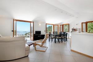 a living room with a couch and a table and chairs at Villa Ciò in Bonassola