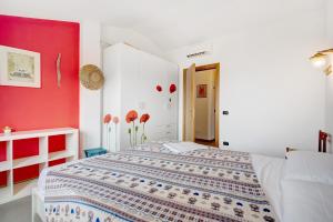 a bedroom with a bed and a red wall at Villa Ciò in Bonassola