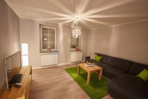 a living room with a couch and a table at Ferienhaus Eifelträume, Birresborn in Birresborn