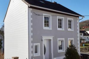 a white house with a black roof at Ferienhaus Eifelträume, Birresborn in Birresborn