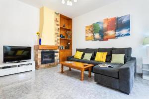 a living room with a couch and a fireplace at Can Navarro in Llucmajor