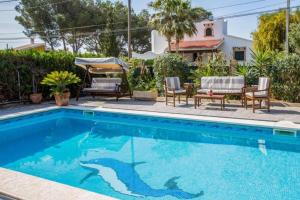 a swimming pool with a shark stencil on the side of a house at Can Navarro in Llucmajor