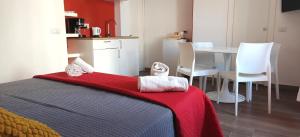a bedroom with a bed and a table and chairs at Appartamenti Mergellina in Naples