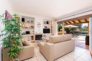 a living room with two couches and a fireplace at Casa Arturo in Sa Coma