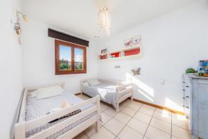 a bedroom with two beds and a window at Casa Arturo in Sa Coma +36 photos