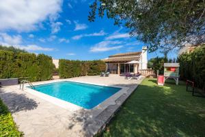 a swimming pool in a yard with a house at Casa Arturo in Sa Coma