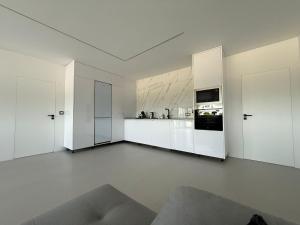 a white kitchen with white cabinets and appliances at Bella Casa Total House in São Francisco