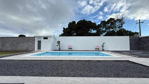 a swimming pool in the backyard of a house at Bella Casa Total House in São Francisco