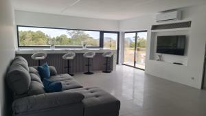 a living room with a couch and a bar at Bella Casa Total House in São Francisco