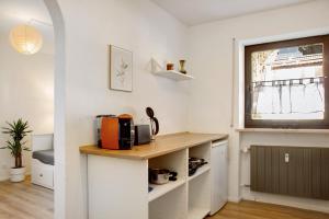 a kitchen with a counter with a microwave and a window at Weinberg in Zeilarn