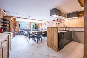 a kitchen and dining room with a table and chairs at Chalet Delphine Luxe, Ski aux pieds in Les Bruyères