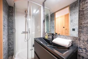 a bathroom with a sink and a shower at Chalet Delphine Luxe, Ski aux pieds in Les Bruyères +21 photos