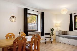 a living room with a dining room table and a couch at Weinberg in Zeilarn
