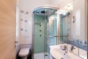 a bathroom with a shower and a sink and a toilet at Agriturismo Green House in Santo Stefano al Mare