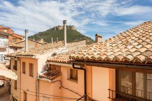 a group of buildings with a mountain in the background at Entre Eras Apto Rural Los Vencejos in Ademuz
