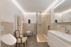 a bathroom with a sink and a toilet and a shower at Ferienwohnung an der Lauter in Indelhausen +86 photos