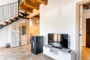 a living room with a large flat screen tv at Entre Eras Apto Rural Los Vencejos in Ademuz