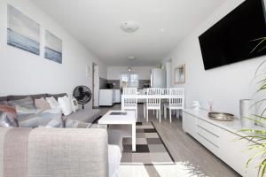a living room with a couch and a table at Casa Helieta in Puerto del Rosario