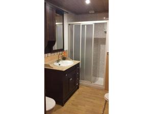 a bathroom with a sink and a toilet and a shower at O Cantón in La Bola +13 photos