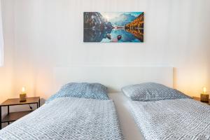 a bedroom with two beds and a picture on the wall at Apartment Jegle in Salem