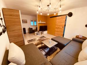 a living room with a couch and a table at Kuća za odmor Bećarsko utočište Vinkovci in Vinkovci