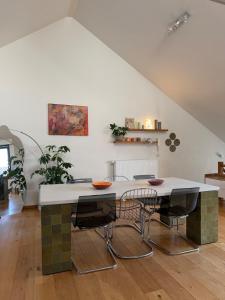 a kitchen with a table and some chairs at Cosy Studio in Mechelen by Studio Pila in Mechelen
