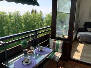 a balcony with a table with plates of food on it at Fuchsenstein 44 in Oberkreuzberg