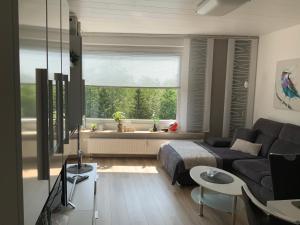 a living room with a couch and a window at Fuchsenstein 44 in Oberkreuzberg