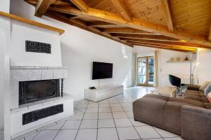 a living room with a couch and a fireplace at Schnitzer Ferienwohnung in Görisried