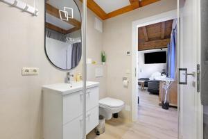 a bathroom with a sink and a toilet and a mirror at Goodlife B10 in Saalbach-Hinterglemm