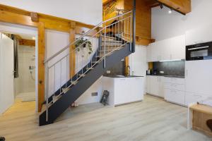 a kitchen with a staircase in the middle of a room at Goodlife B10 in Saalbach-Hinterglemm +28 photos