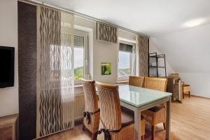 a dining room with a glass table and chairs at Ferienwohnung Dani in Koetz 