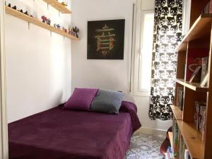 a bedroom with a purple bed and a window at Reconnectar Malgrat de Mar Emili in Malgrat de Mar +10 photos