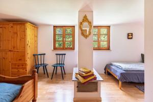 a bedroom with a bed and a table with books at Ferien Alm Alfret in Herrischried