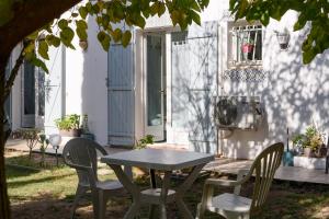 a table and chairs in front of a house at Chambres D'hôtes in Saint-Cyprien +34 photos