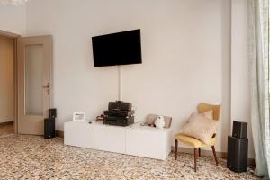 a living room with a tv on a white wall at De Rolandis in Asti