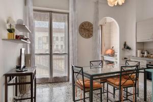 a dining room with a table and chairs and a clock at De Rolandis in Asti