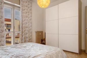 a bedroom with a large white cabinet and a bed at De Rolandis in Asti
