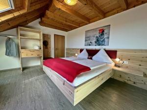 a bedroom with a large bed with a red blanket at Ferienhaus Bührer in Freiamt +52 photos