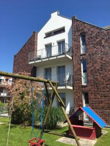 a playground in front of a building at Ferienhaus Jümmers - Sönke in Horumersiel