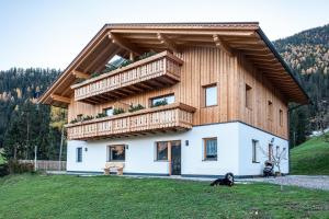 a house with a balcony on top of it at Mittnackerhof Apartment Ringelblume in Sarntal