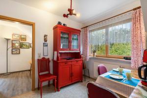 a living room with a red cabinet and a table at Haus im Grünen in Oederan