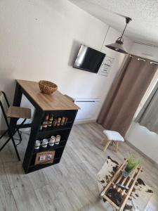 a living room with a table and a chair at Studio rénové avec terrasse, parking , proche pistes,Villard de Lans in Villard-de-Lans