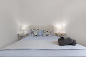 a bedroom with a bed with two night stands at Lirio Blanco de las Dunas Canarias in Playa del Ingles +17 photos