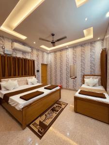 a bedroom with two beds and a ceiling at Vijay palace 850 meter away from Ram mandir in Ayodhya