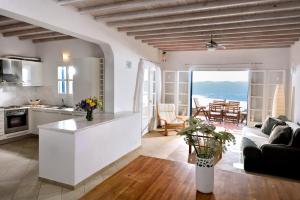 a kitchen and living room with a view of the ocean at Wonderful Villa Chrysta in Mikonos