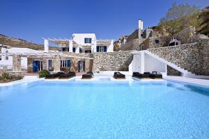 a large swimming pool in front of a villa at Wonderful Villa Chrysta in Mikonos